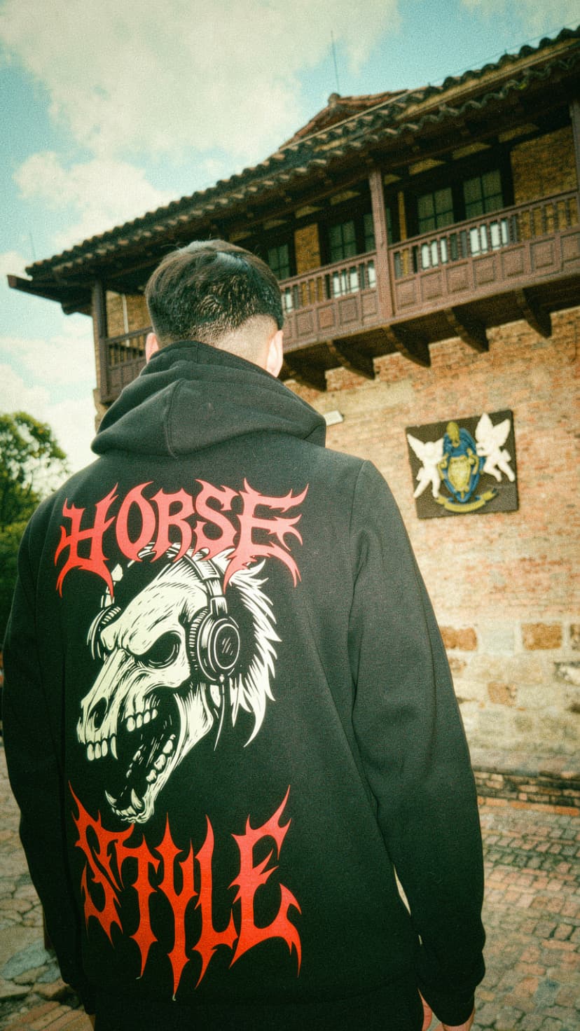 ANDY EMBER photographed from behind in a Bogota street setting