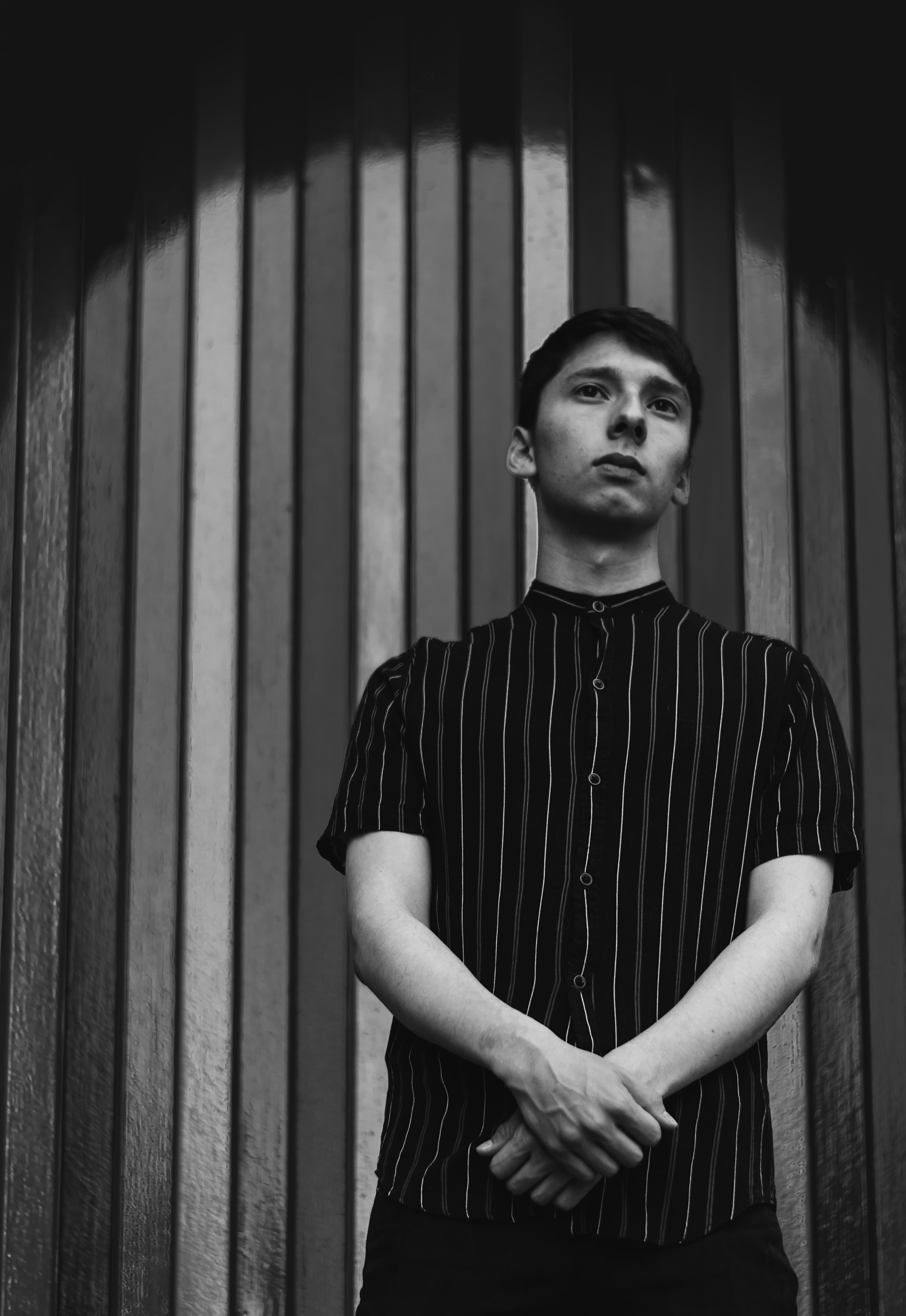 Black and white full-body portrait of ANDY EMBER